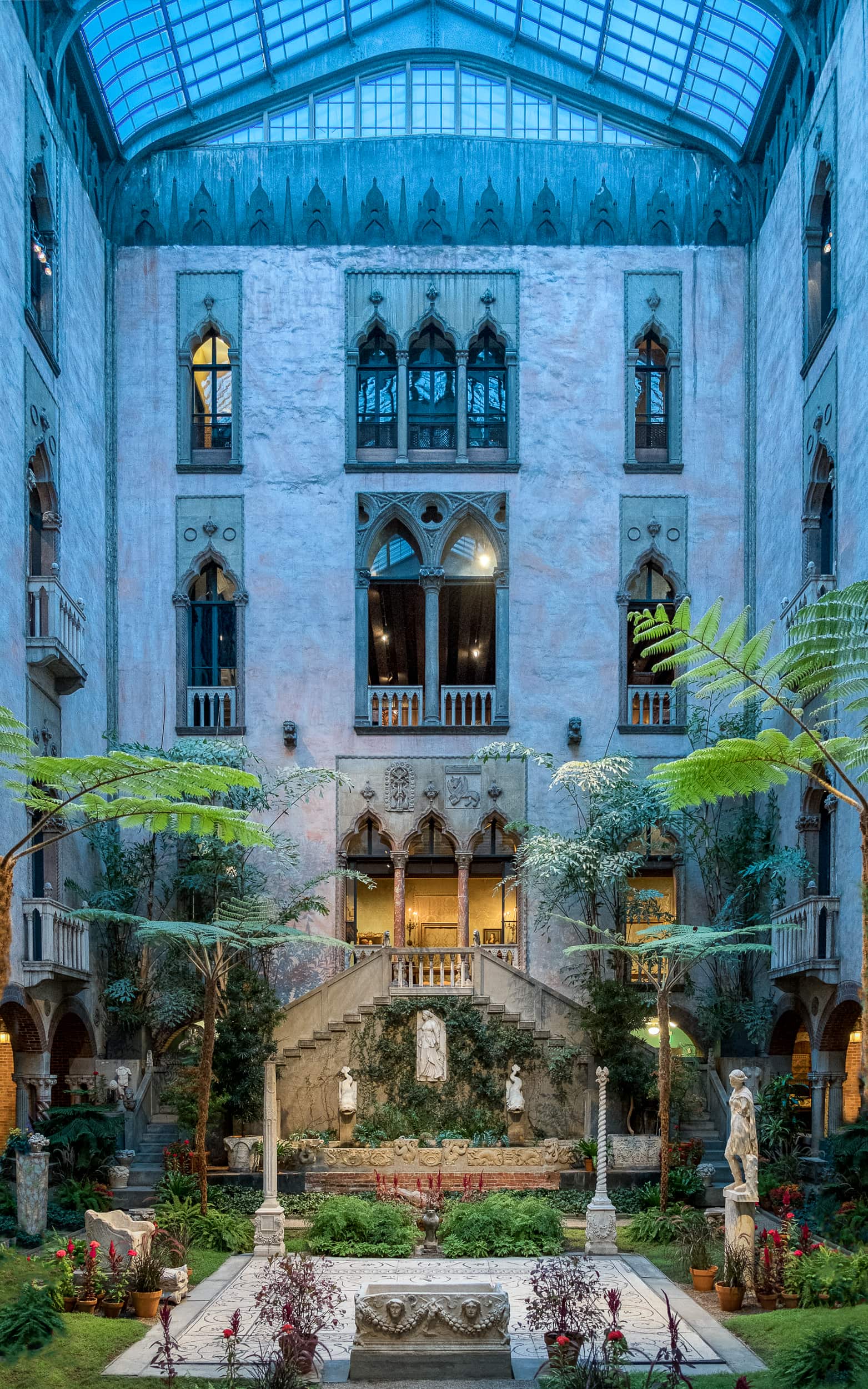 Architectural photography of the Isabella Stewart Gardener Museum in Boston Massachusetts featuring the dramatic courtyard alit in blue hour light
